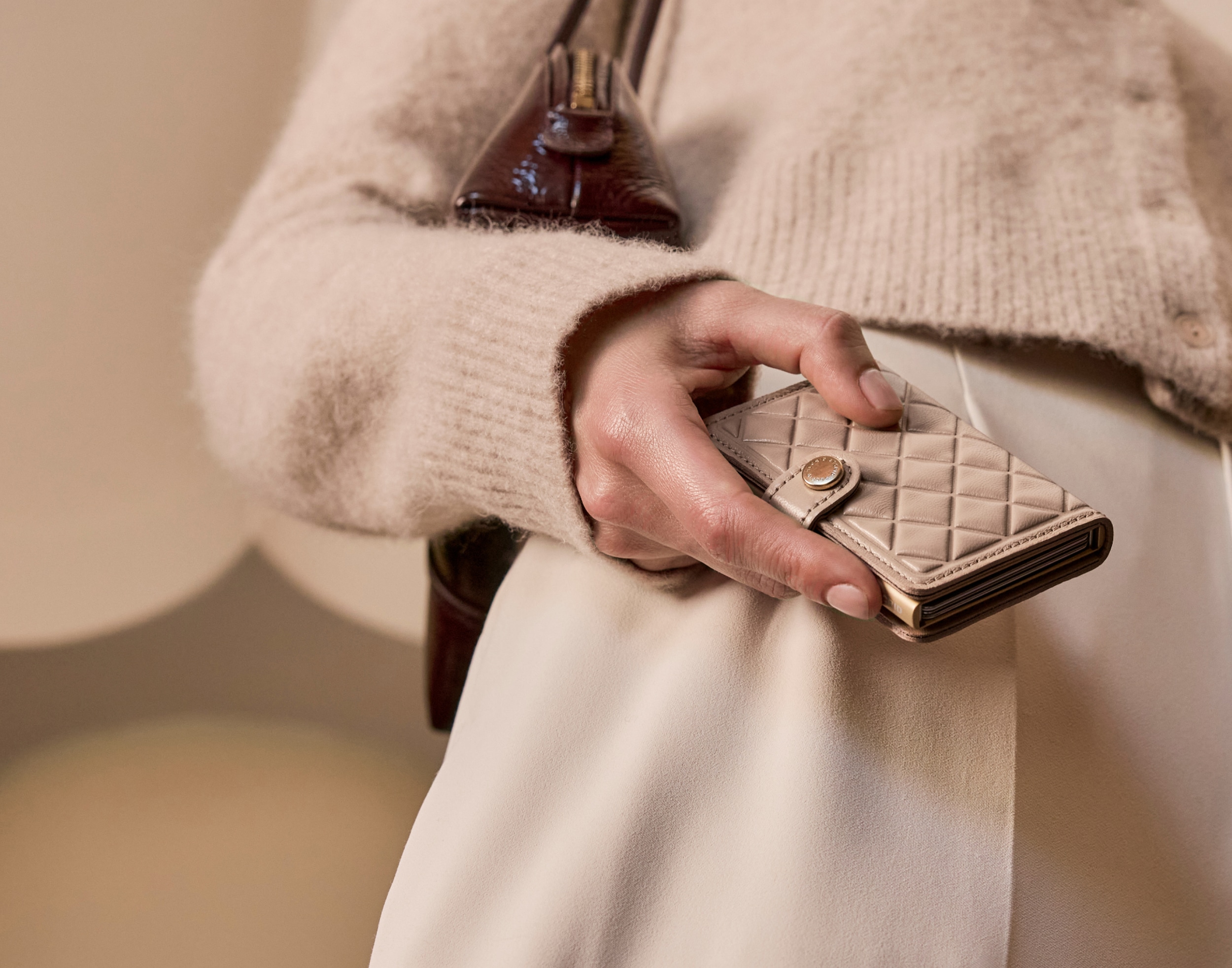 Woman holding a white diamond patterned card holder