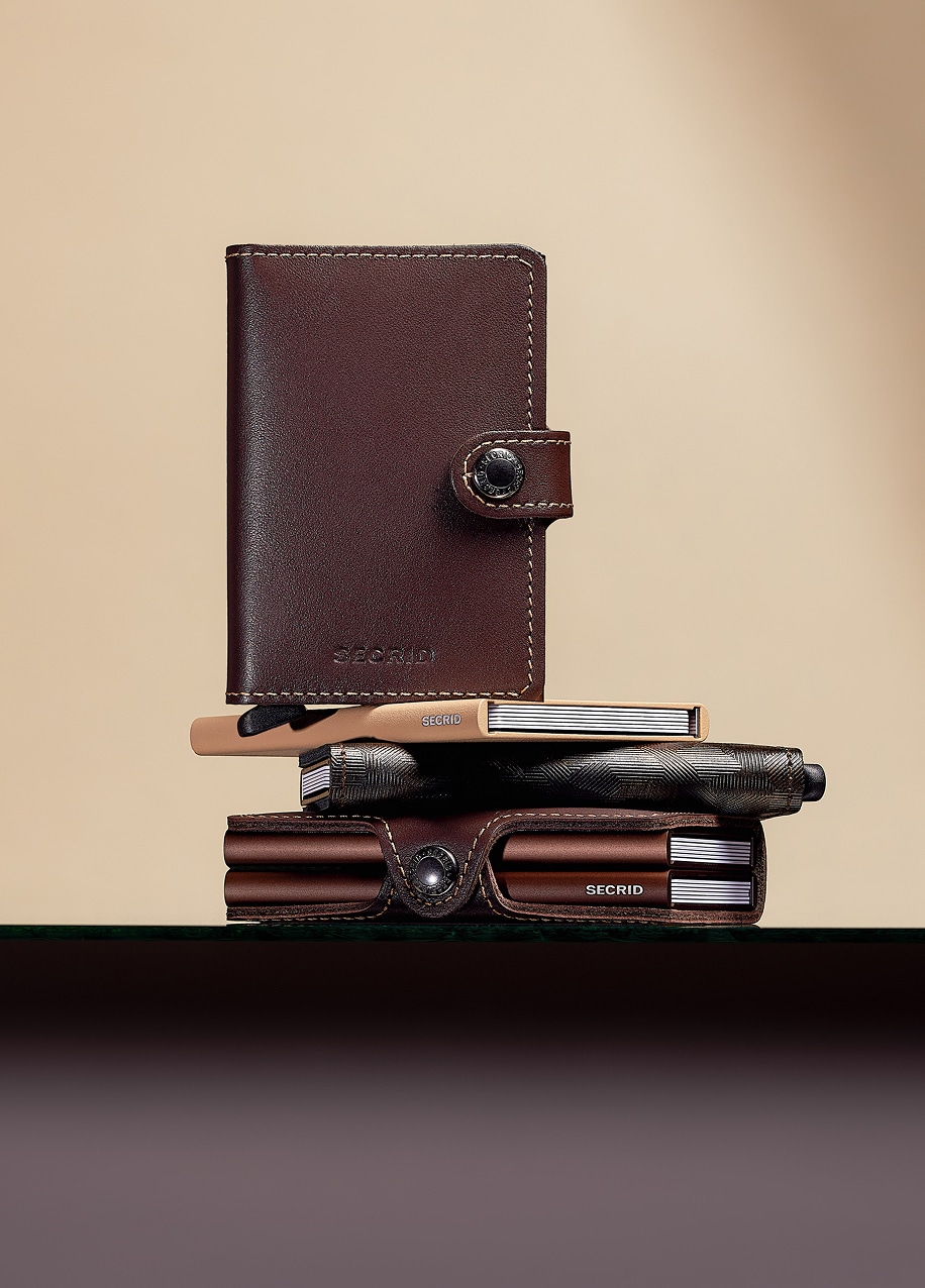 A stack of brown card holders of different sizes